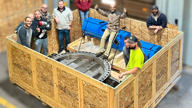 Employees inside shipping crate