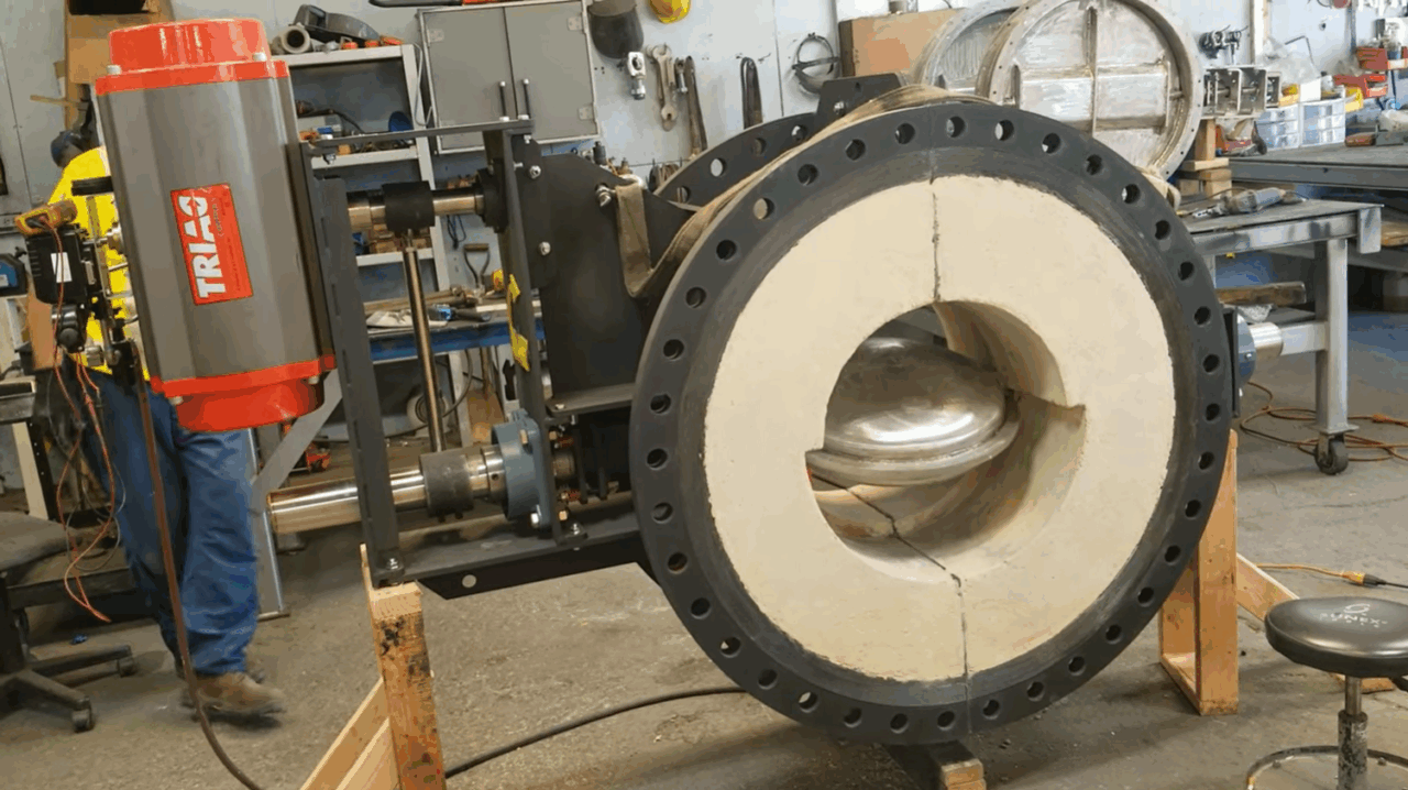 Water cooled disc and shaft installed in refractory lined damper